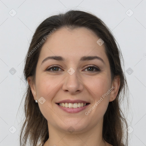 Joyful white young-adult female with long  brown hair and brown eyes