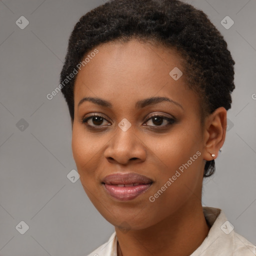 Joyful black young-adult female with short  brown hair and brown eyes