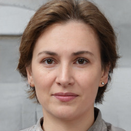 Joyful white adult female with medium  brown hair and brown eyes