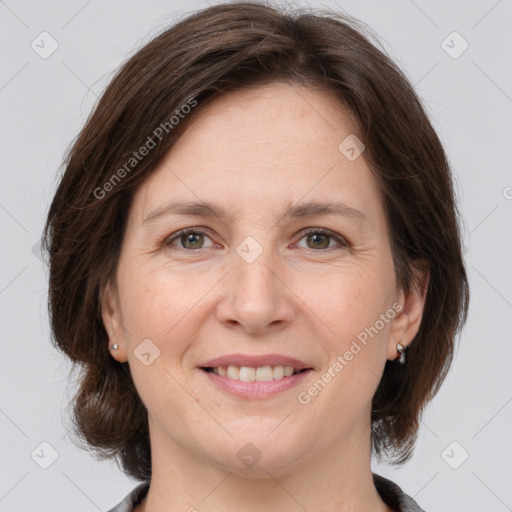 Joyful white adult female with medium  brown hair and grey eyes