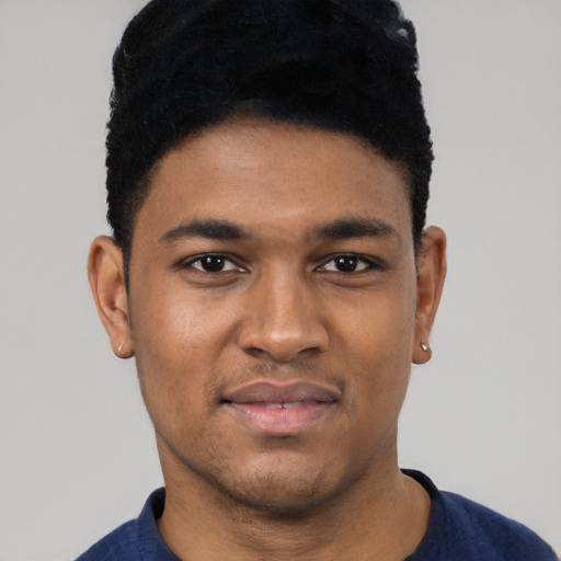Joyful black young-adult male with short  black hair and brown eyes