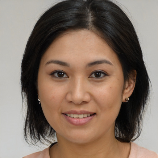 Joyful asian young-adult female with medium  brown hair and brown eyes