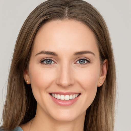 Joyful white young-adult female with long  brown hair and grey eyes