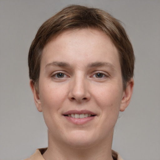 Joyful white young-adult female with short  brown hair and grey eyes