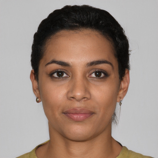 Joyful latino young-adult female with short  black hair and brown eyes
