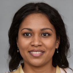 Joyful black young-adult female with medium  brown hair and brown eyes