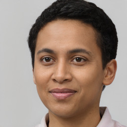 Joyful latino young-adult male with short  brown hair and brown eyes