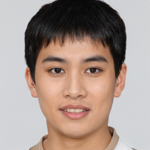 Joyful asian young-adult male with short  brown hair and brown eyes