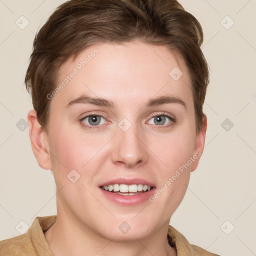 Joyful white young-adult female with short  brown hair and grey eyes