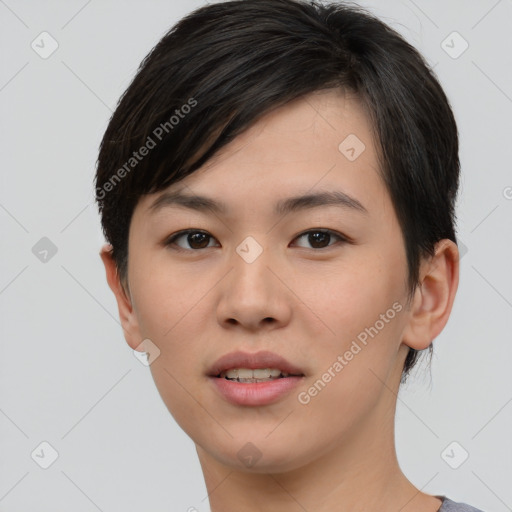 Joyful asian young-adult female with short  black hair and brown eyes