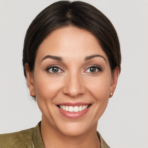 Joyful white young-adult female with short  brown hair and brown eyes