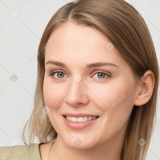 Joyful white young-adult female with long  brown hair and grey eyes