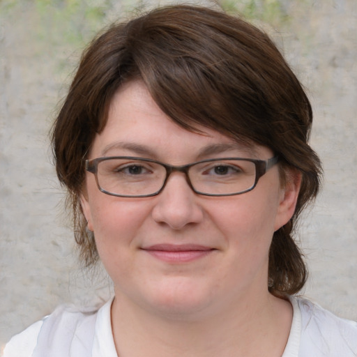 Joyful white adult female with medium  brown hair and blue eyes