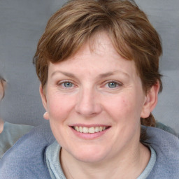 Joyful white young-adult female with medium  brown hair and blue eyes