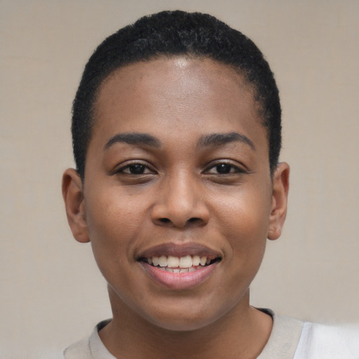 Joyful black young-adult female with short  black hair and brown eyes