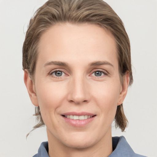 Joyful white adult female with medium  brown hair and grey eyes