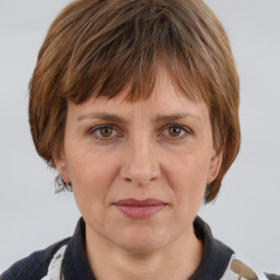 Joyful white adult female with medium  brown hair and grey eyes