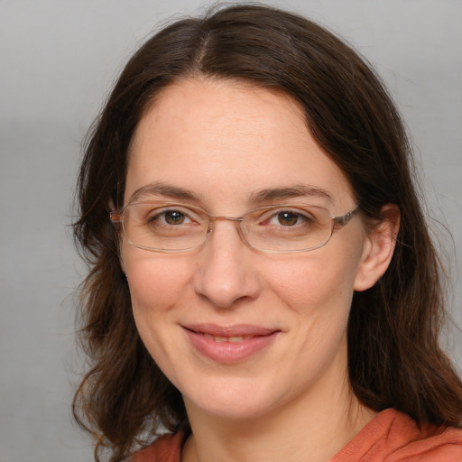 Joyful white adult female with medium  brown hair and grey eyes