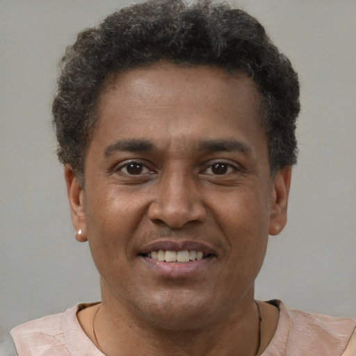 Joyful latino young-adult male with short  brown hair and brown eyes