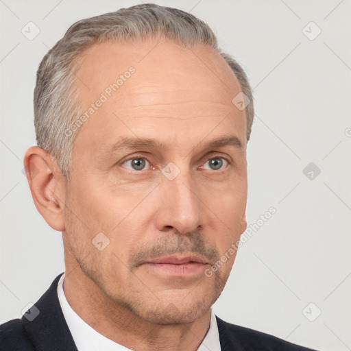 Neutral white middle-aged male with short  gray hair and brown eyes