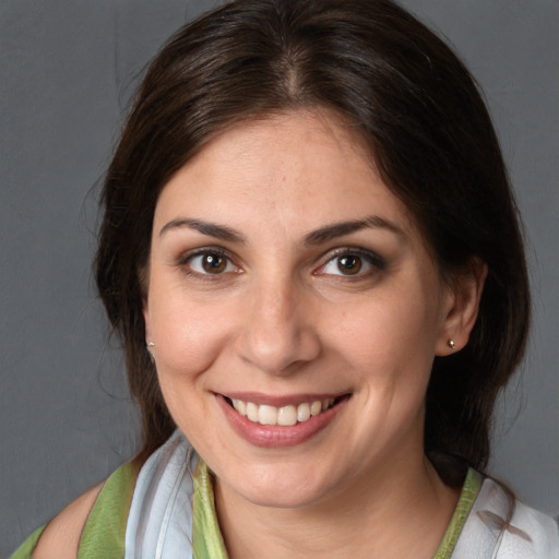 Joyful white young-adult female with medium  brown hair and brown eyes