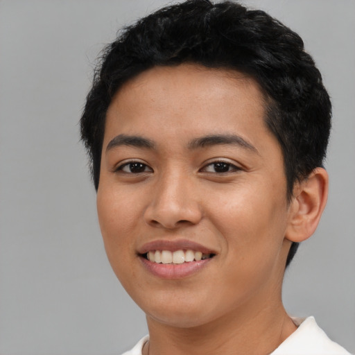 Joyful latino young-adult female with short  black hair and brown eyes