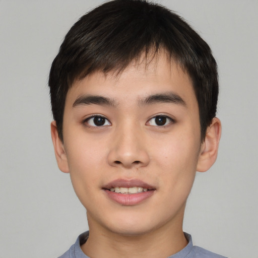 Joyful asian young-adult male with short  brown hair and brown eyes