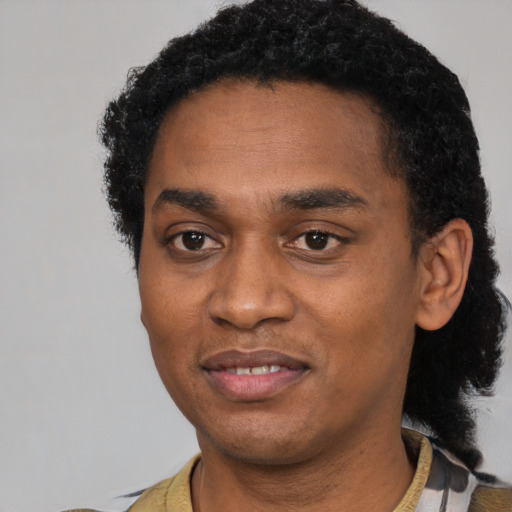 Joyful black young-adult male with short  black hair and brown eyes