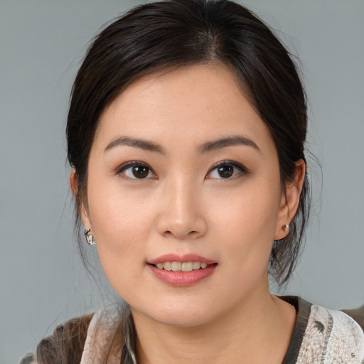 Joyful asian young-adult female with medium  brown hair and brown eyes