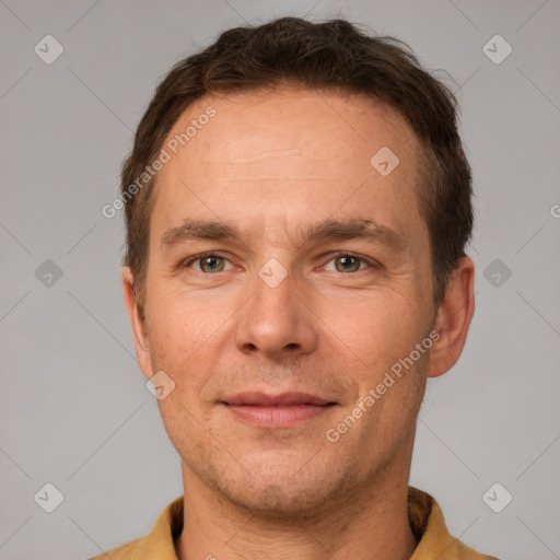 Joyful white adult male with short  brown hair and grey eyes