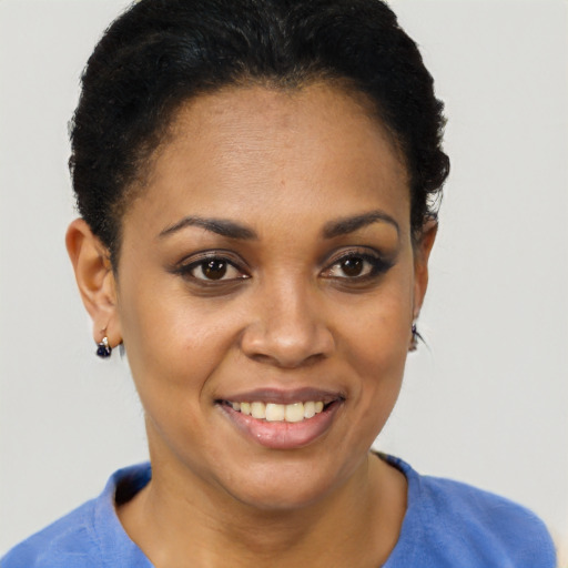 Joyful black young-adult female with short  black hair and brown eyes