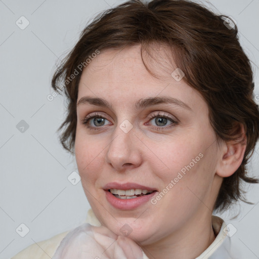 Joyful white young-adult female with medium  brown hair and blue eyes