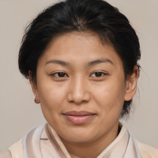 Joyful asian young-adult female with medium  brown hair and brown eyes