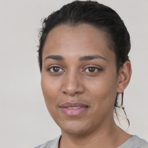 Joyful latino young-adult female with short  black hair and brown eyes