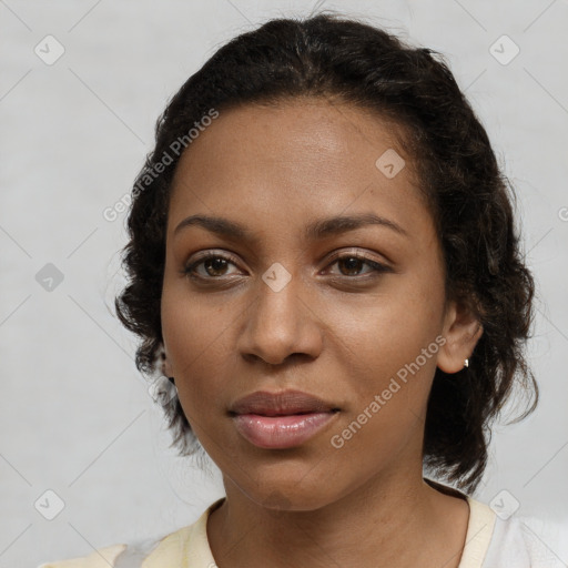 Joyful black young-adult female with medium  brown hair and brown eyes