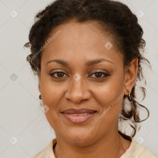 Joyful black adult female with medium  brown hair and brown eyes