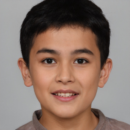 Joyful white child male with short  brown hair and brown eyes
