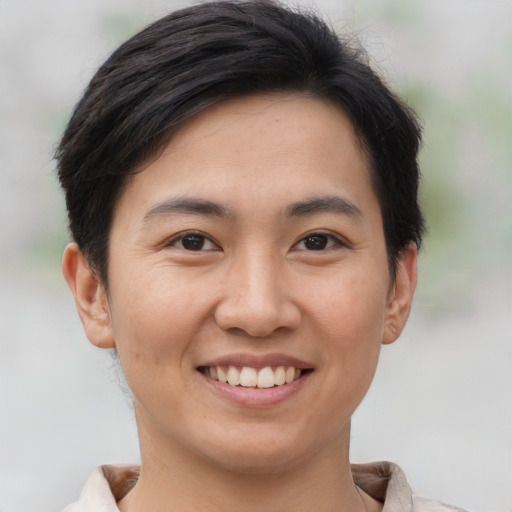 Joyful asian young-adult female with short  brown hair and brown eyes