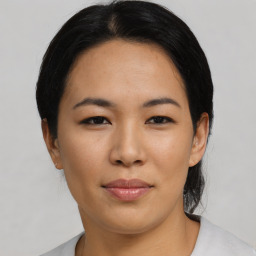 Joyful asian young-adult female with short  black hair and brown eyes