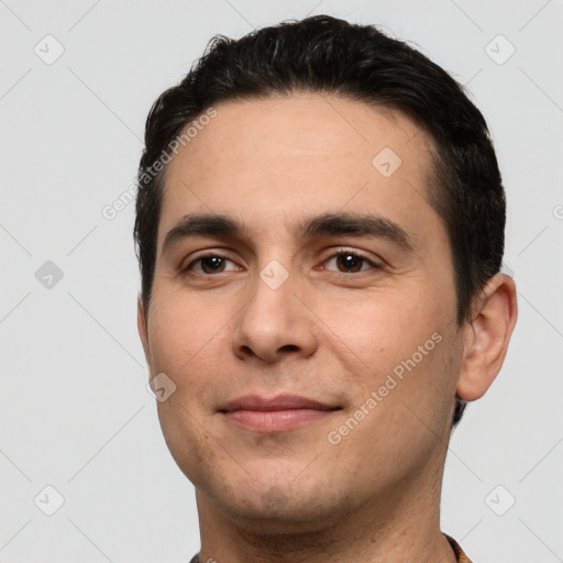 Joyful white young-adult male with short  black hair and brown eyes