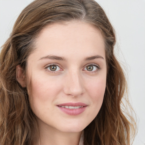 Joyful white young-adult female with long  brown hair and blue eyes