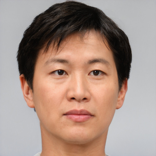 Neutral asian adult male with short  brown hair and brown eyes