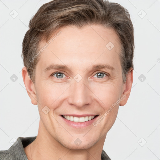 Joyful white adult male with short  brown hair and grey eyes