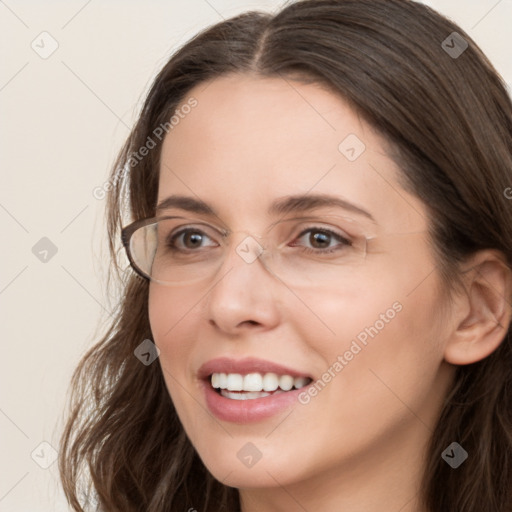 Joyful white young-adult female with long  brown hair and grey eyes