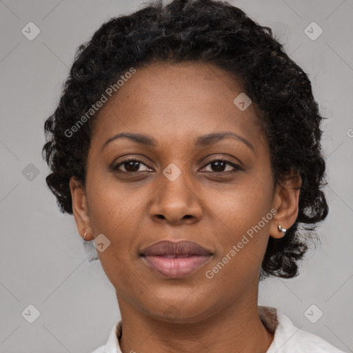 Joyful black adult female with short  brown hair and brown eyes