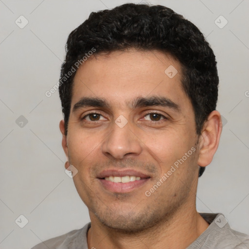 Joyful white young-adult male with short  black hair and brown eyes