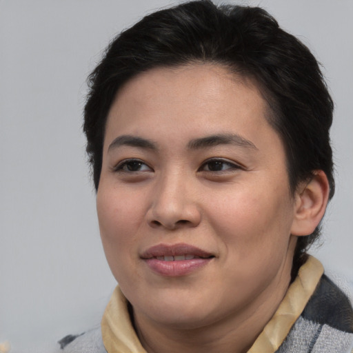 Joyful asian young-adult female with medium  brown hair and brown eyes