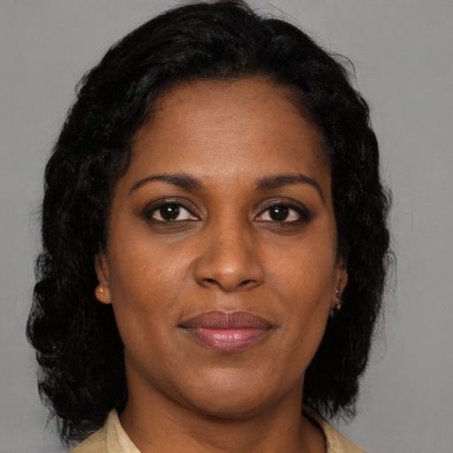 Joyful black young-adult female with medium  brown hair and brown eyes
