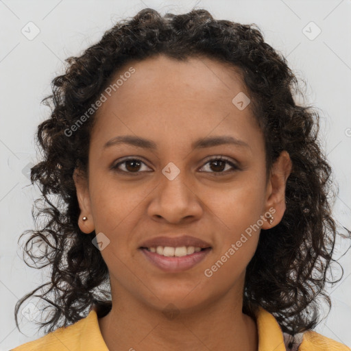 Joyful black young-adult female with long  brown hair and brown eyes