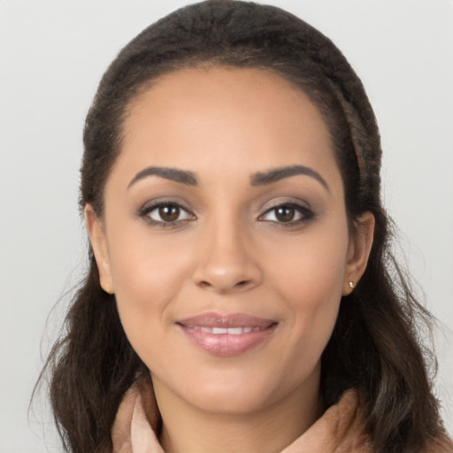 Joyful latino young-adult female with long  brown hair and brown eyes